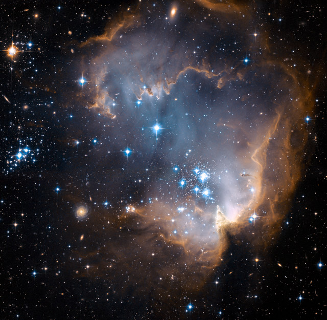This new image taken with NASA's Hubble Space Telescope depicts bright, blue, newly formed stars that are blowing a cavity in the center of a star-forming region in the Small Magellanic Cloud.