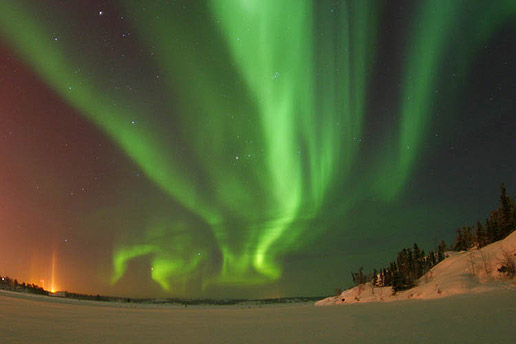 An aurora from the ground at Yellowknife, NT in December 2004. Without magnetic storms, aurora would be featureless glows in the sky. Magnetic fields provide the pathways for currents to flow into the atmosphere in particular patterns controlled by the magnetic forces and their changes through time. (Courtesy: Andrew Eaton)