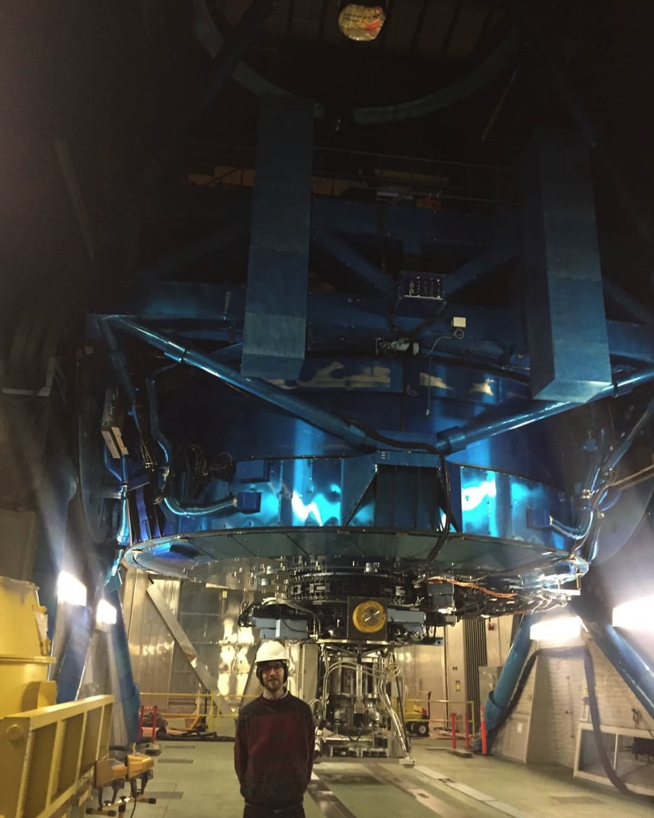 Standing beneath the 8.2m Subaru Telescope on Mauna Kea in Hawaii before an observing run. This telescope conducted most of the observations I worked with throughout both undergrad and grad school. You could argue that every photograph of me since December 25, 2021 has been a picture of me standing beneath the telescope I now use primarily (JWST).